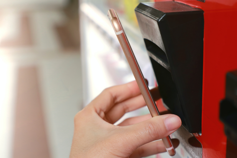 Hand,holding,smartphone,for,scanning,qr,code,or,barcode,by