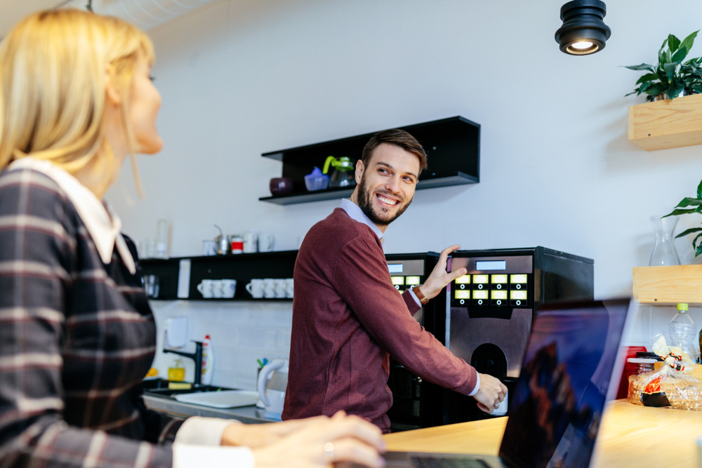 Shot,of,a,young,couple,talking,in,an,office,cafeteria.