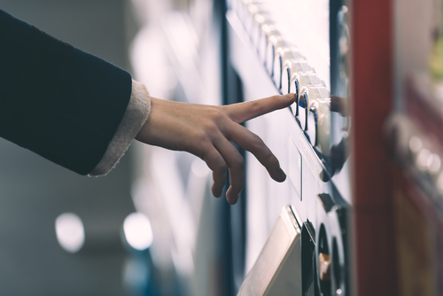 Woman,buying,with,a,vending,machine